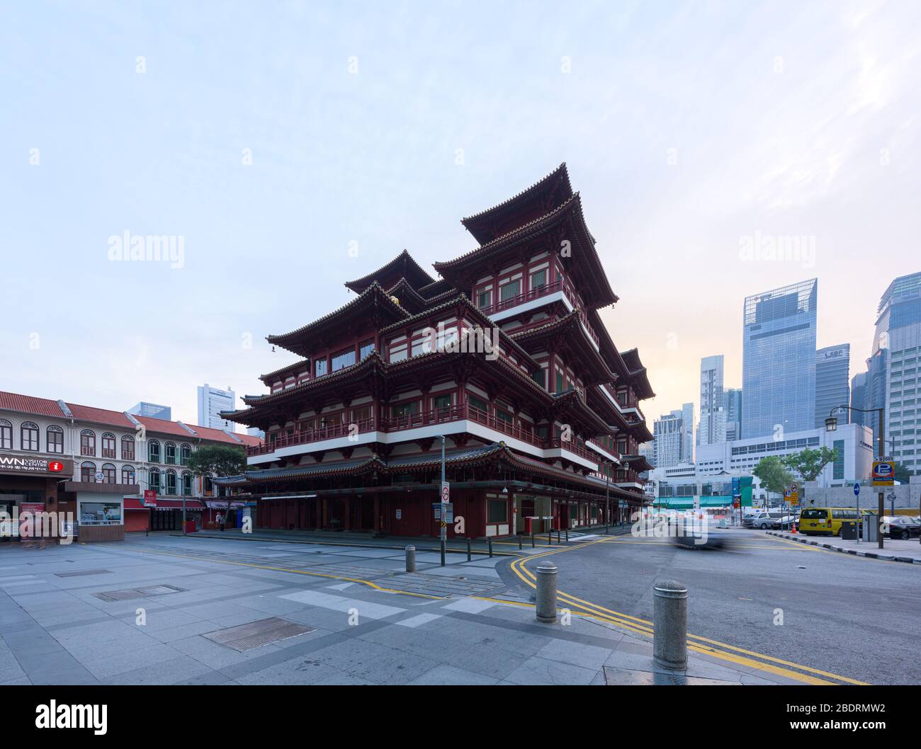 Singapore - 31 Oct 2019: a car passes around of the Buddha Tooth Relic Chinese Temple, at sunrise, in downtown Singapore Stock Photo