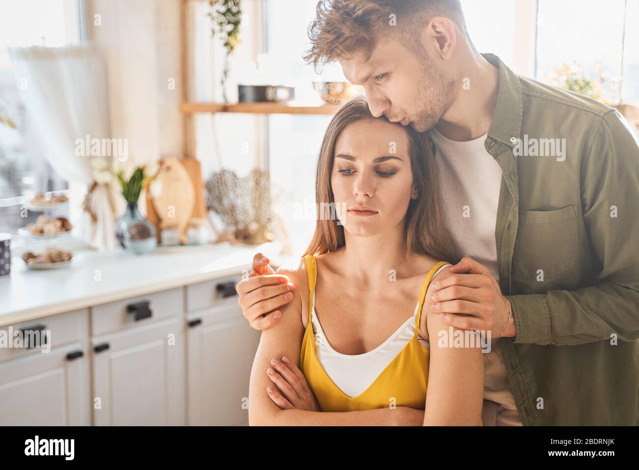 Kind young male person kissing his girlfriend Stock Photo