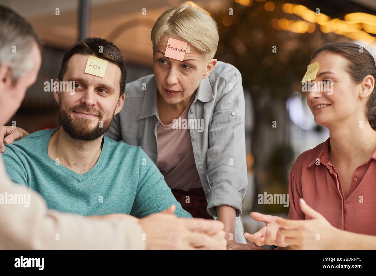 Family of four sitting at the table and having fun together they