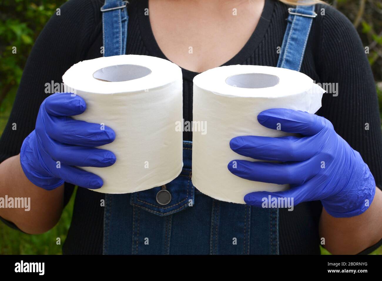 The last two rolls of toilet paper in the hands of a lady wearing