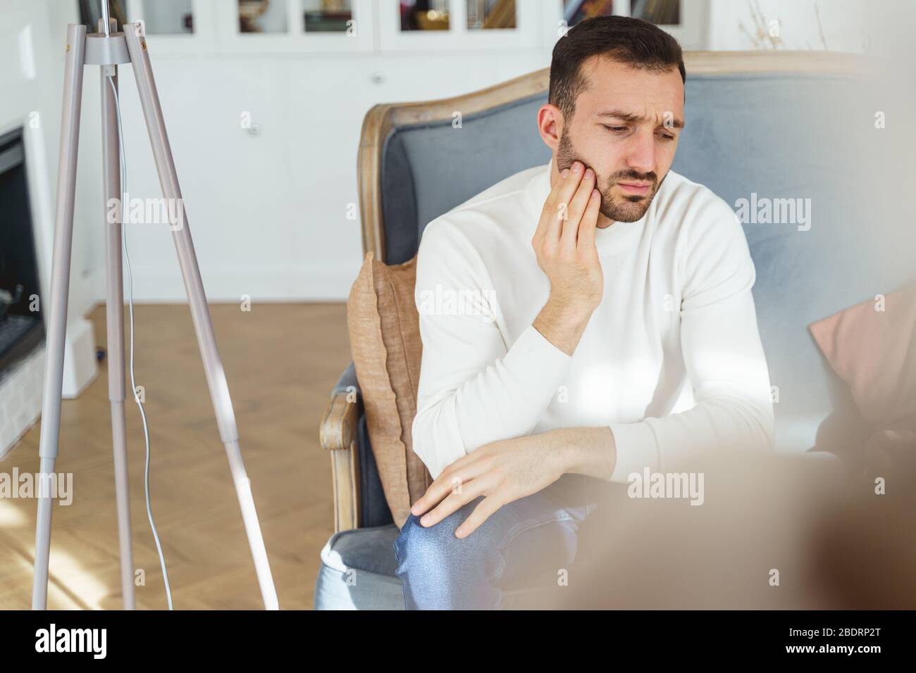 Young Caucasian man suffering from a toothache Stock Photo