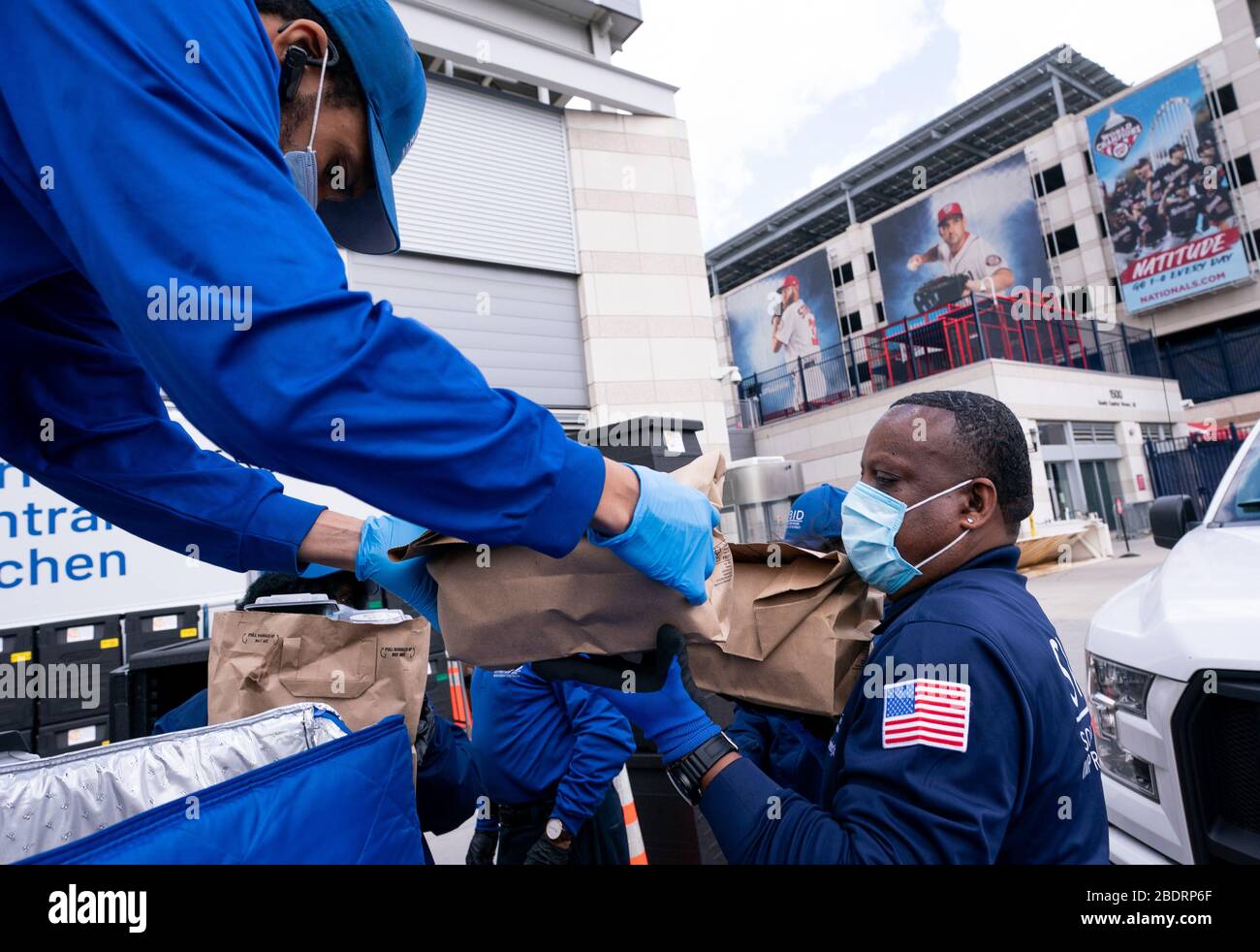 Washington, United States. 09th Apr, 2020. Workers with the nonprofit group SWBID pick up food to distribute to those in need from World Central Kitchen's makeshift distribution site at Nationals Park in Washington, DC on Thursday, April 9, 2020. Jose Andres's World Central Kitchen is using Nationals Park to prepare and distribute food to agencies that help needed individuals during the Coronavirus pandemic. Photo by Kevin Dietsch/UPI Credit: UPI/Alamy Live News Stock Photo