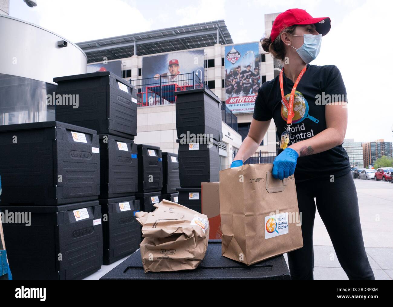 Washington, United States. 09th Apr, 2020. A volunteer with World Central Kitchen's helps distribute food at a distribution site at Nationals Park in Washington, DC on Thursday, April 9, 2020. Jose Andres's World Central Kitchen is using Nationals Park to prepare and distribute food to agencies that help needed individuals during the Coronavirus pandemic. Photo by Kevin Dietsch/UPI Credit: UPI/Alamy Live News Stock Photo