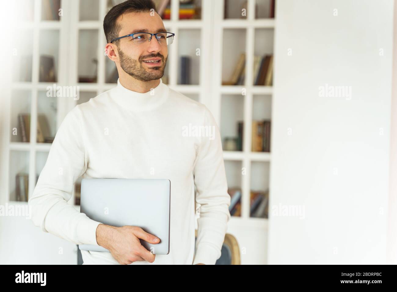 Handsome office worker standing in the workplace Stock Photo