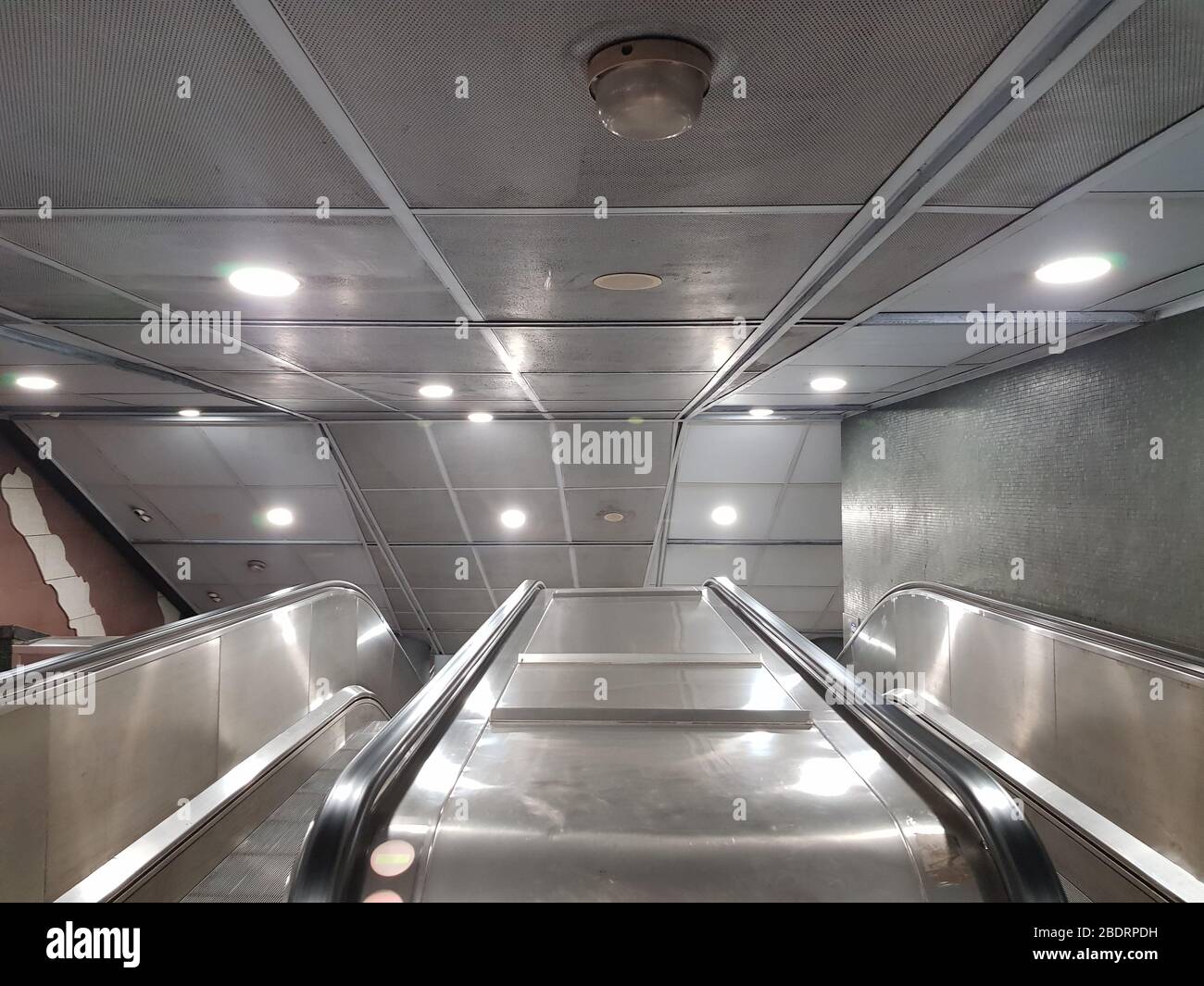 Entrance of moving escalator on subway station with no people Stock Photo
