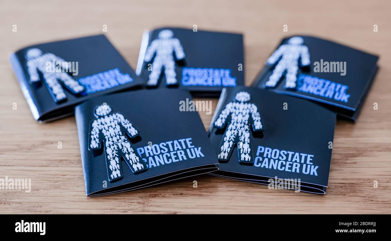 Close up of Prostate Cancer UK badge pins to encourage charity donation to raise funds to raise awareness of common health condition, United Kingdom Stock Photo