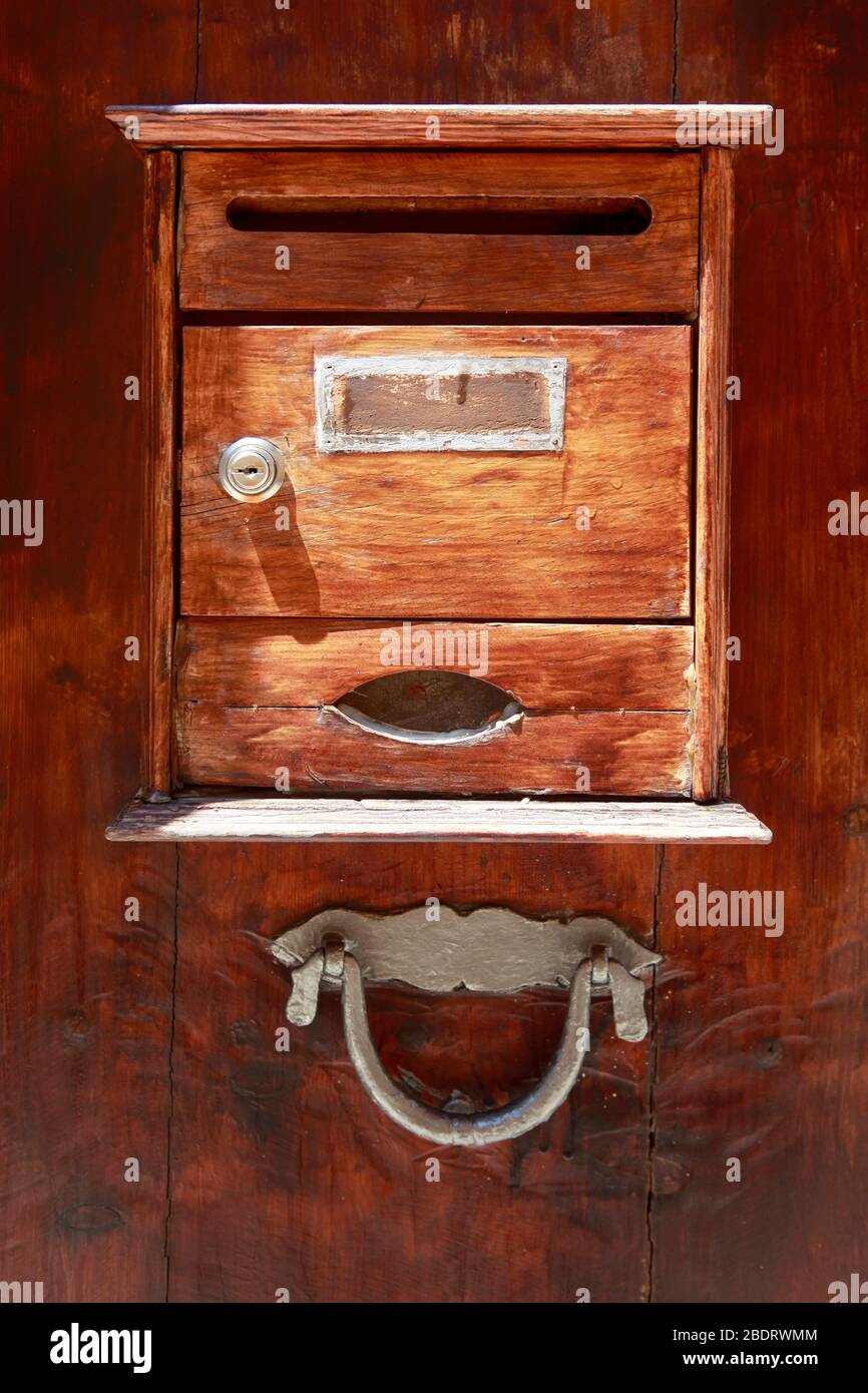 vintage wooden mailbox on a wooden door. Alcudia, Mallorca Stock Photo