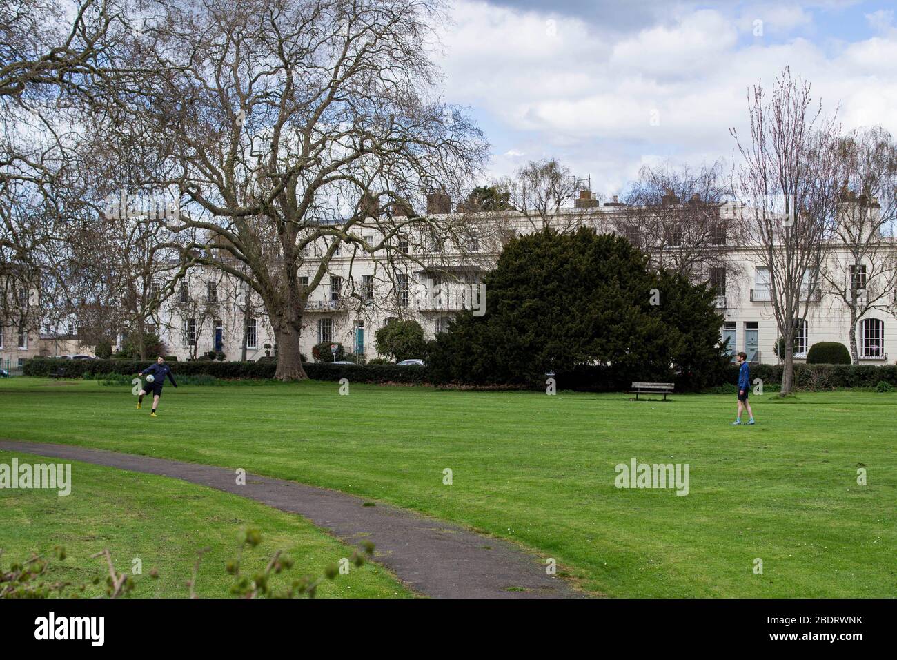Two boys play football on Clarence Square in Cheltenham, England. Lewis