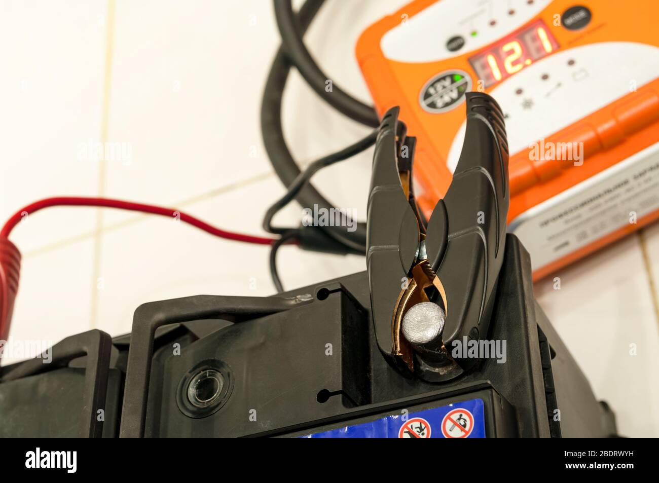 Wire attached to both battery terminals hires stock photography and