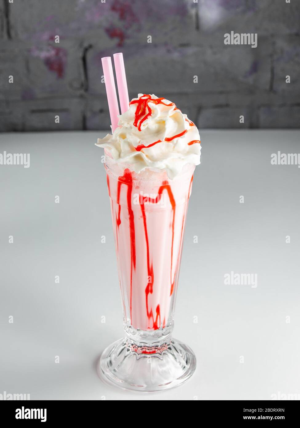 strawberry milkshake with whipped cream and strawberry syrup Stock