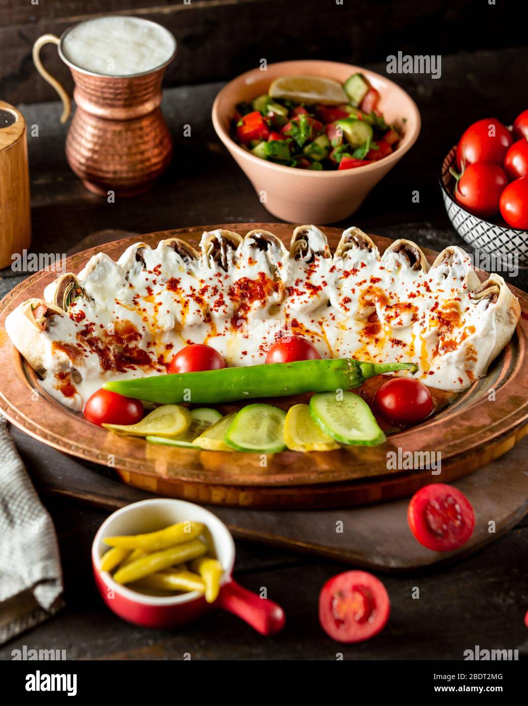 side view of flatbread kebab doner slices garnished with yogurt and