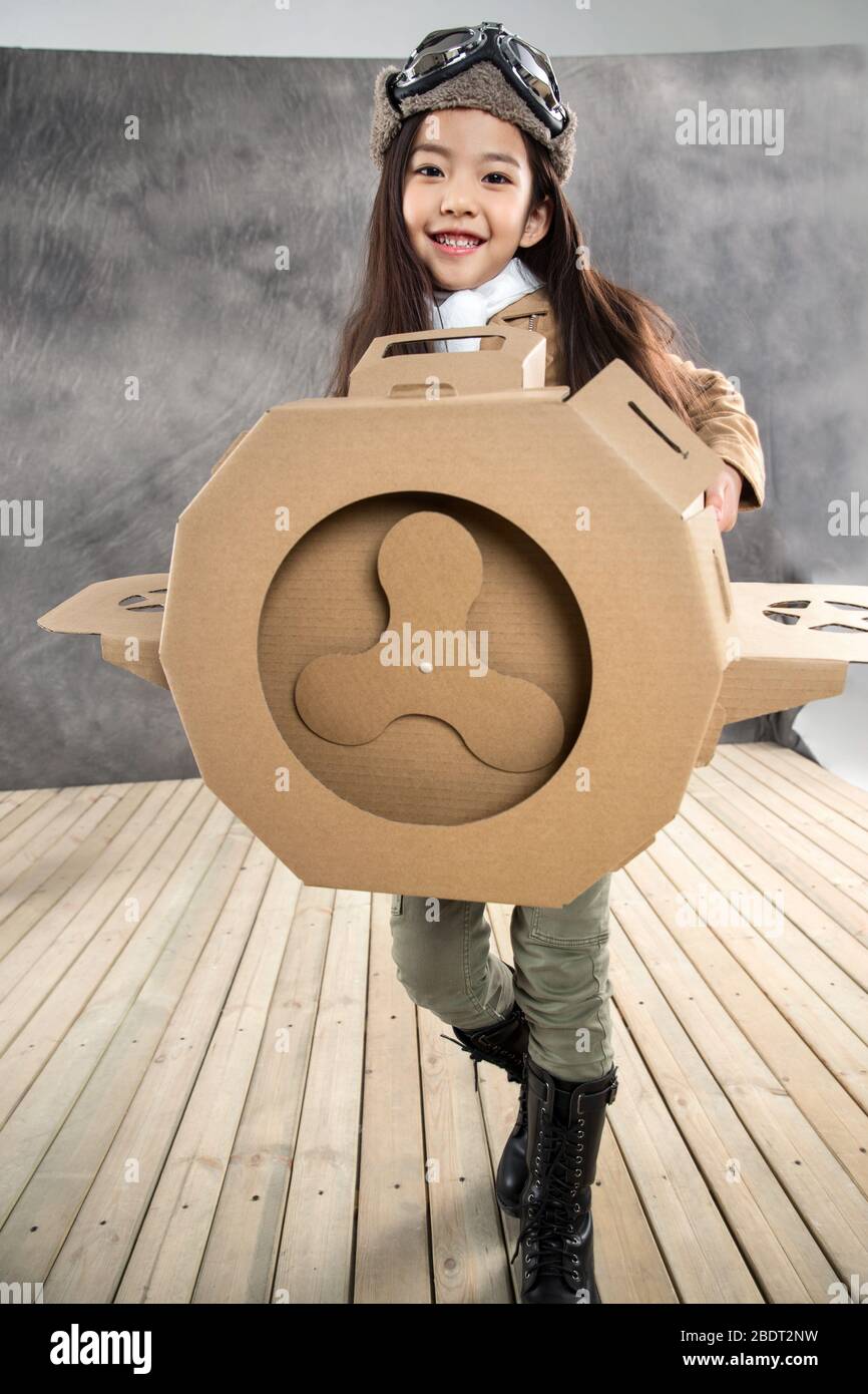 Happy girl driving paper airplanes Stock Photo - Alamy