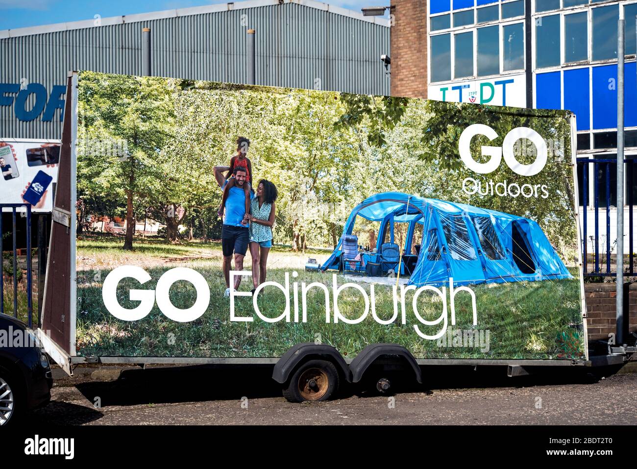 Go Outdoors advertising trailer with damaged wheels parked near their store at Granton, Edinburgh, Scotland, UK. Stock Photo