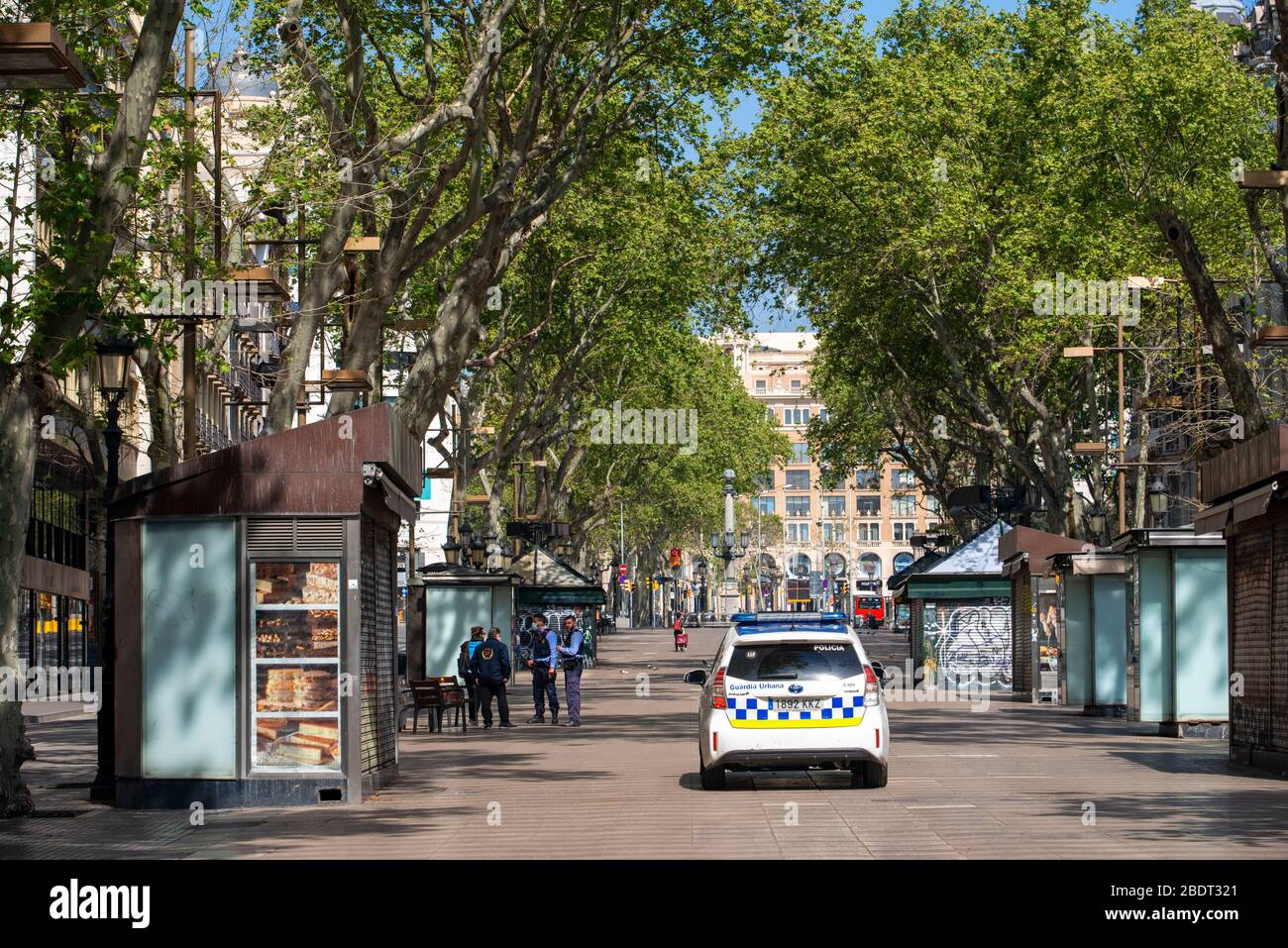 Police inspect confinement. The Ramblas in Barcelona is practically deserted due to the total confinement of the population in Spain. Spain is one of Stock Photo