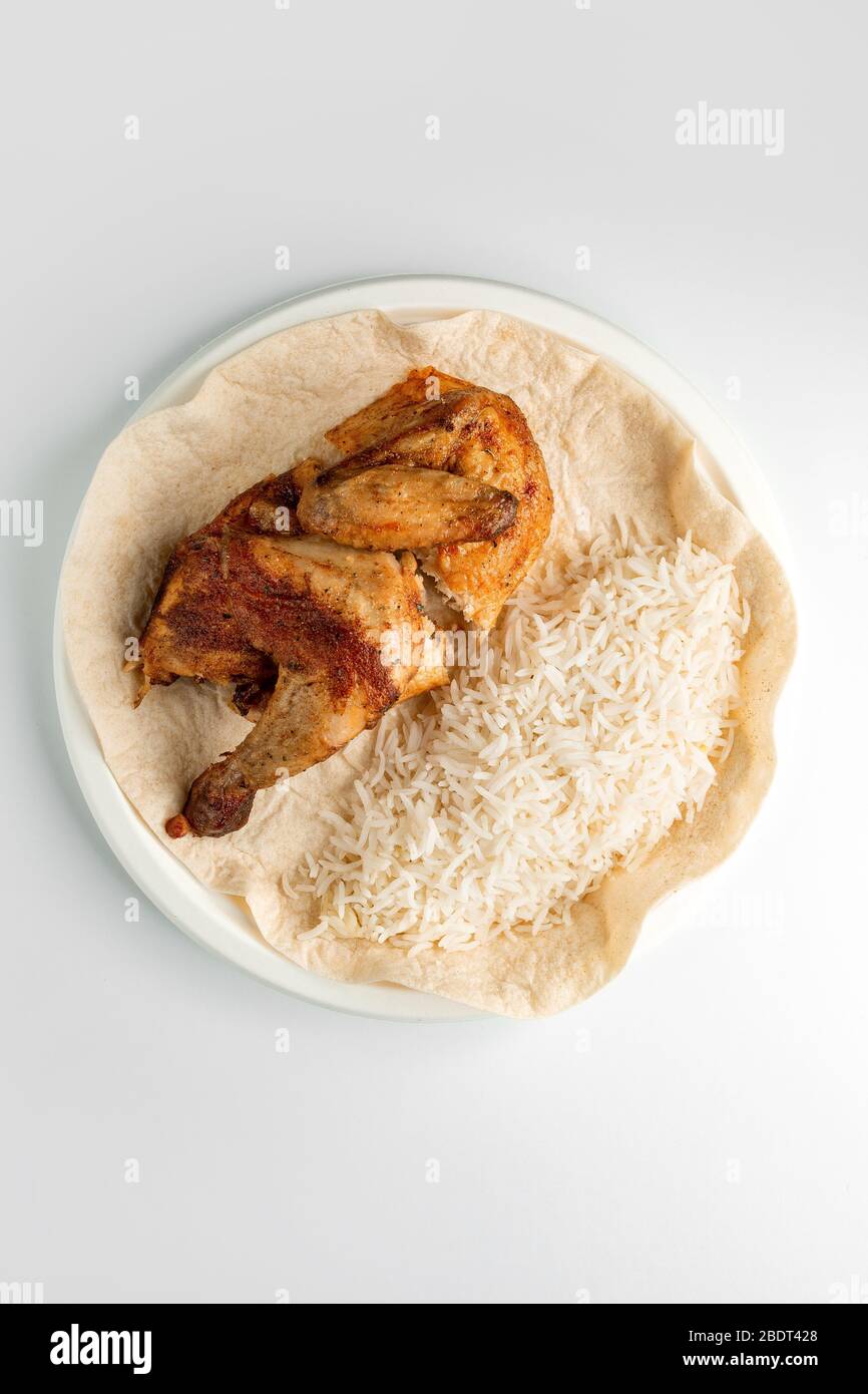 top view of whole grilled chicken and rice served on flatbread Stock ...