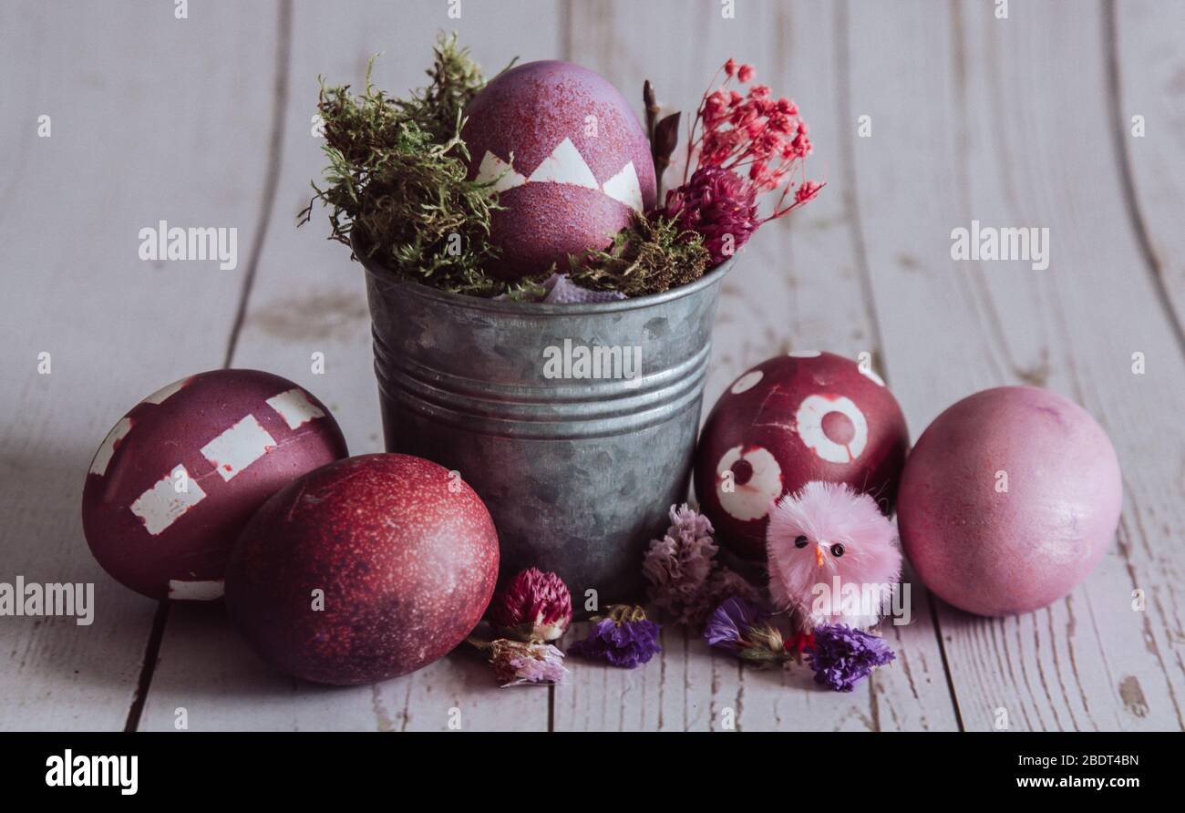 Rose colored Easter composition. Easter eggs on a Rustic background. Stock Photo