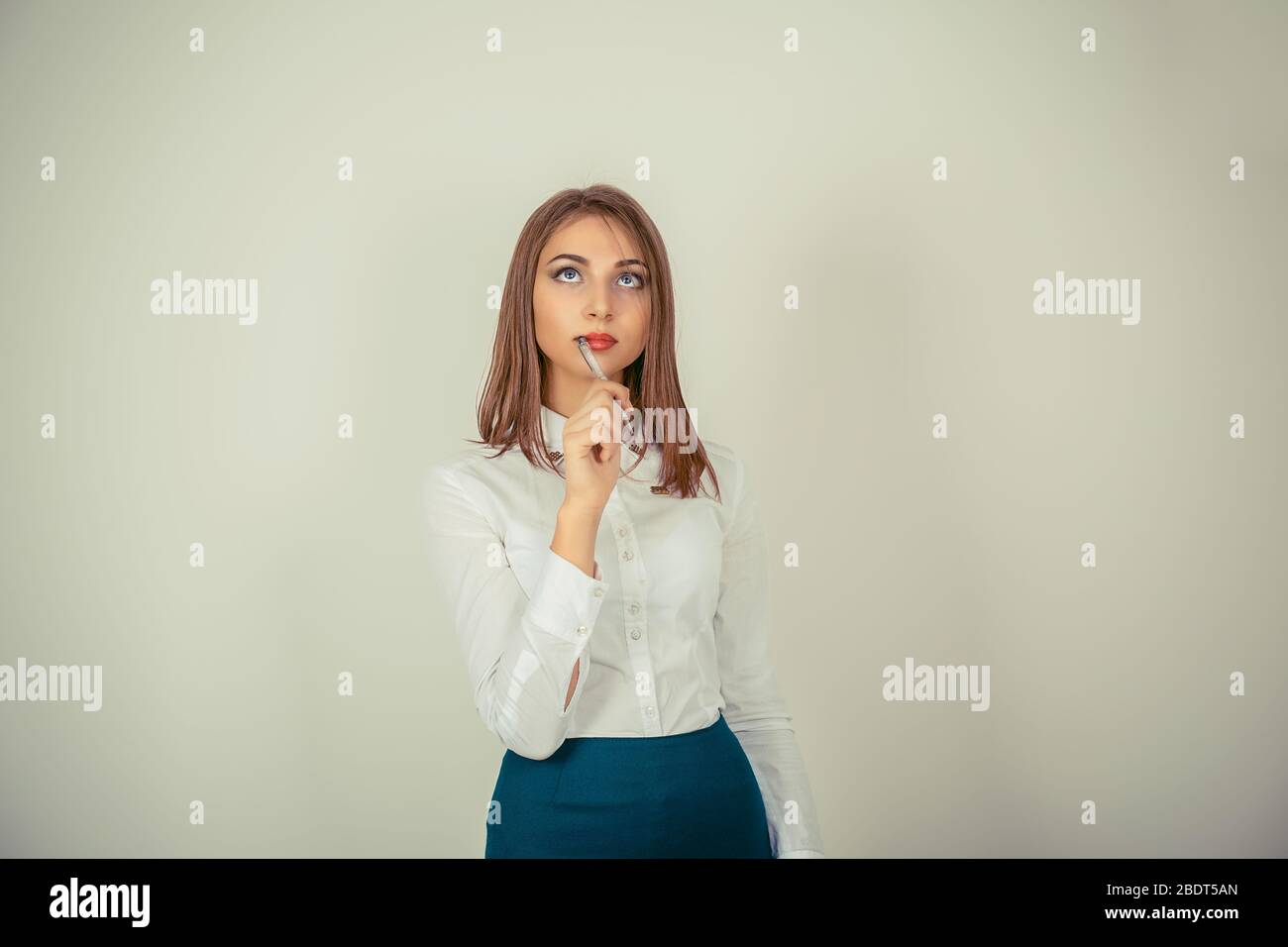 Pondering, planning. Closeup portrait of young woman thinking daydreaming deeply about something looking up isolated on white green background. Human Stock Photo