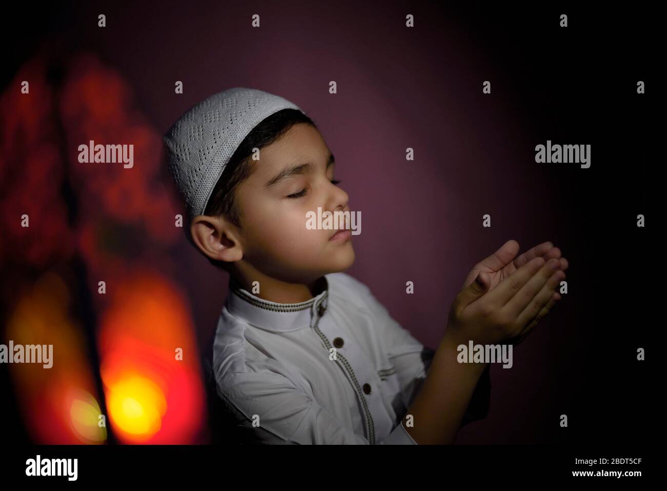 Muslim child praying in the mosque. Little middle-eastern boy prays to ...