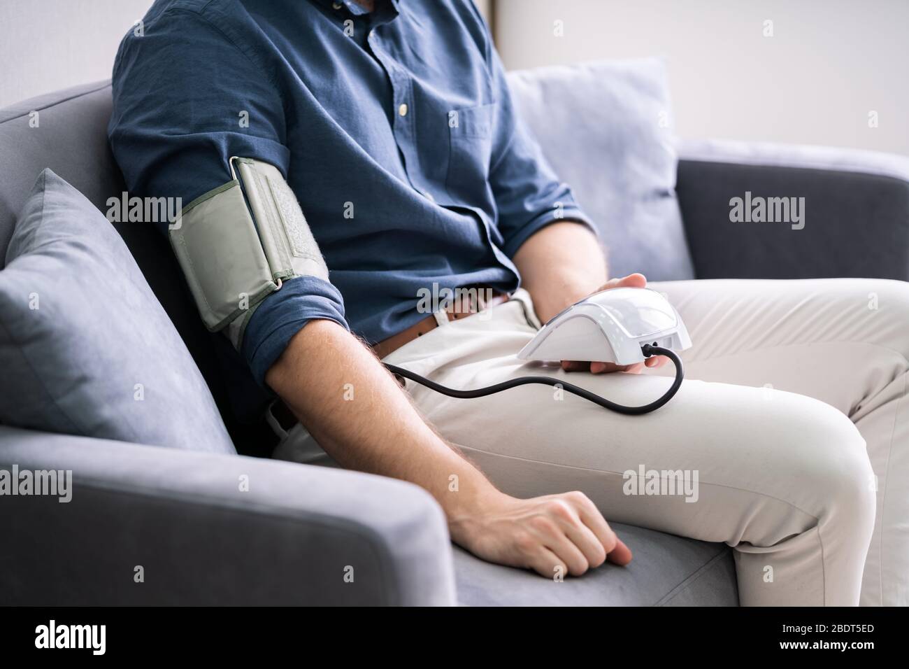 Man Checking Blood Pressure At Home. Chronic Disease Stock Photo