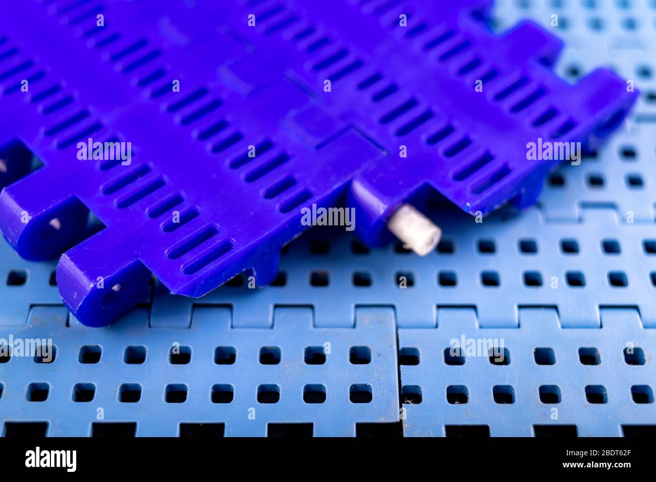 Plastic modular belt. Accessories for the food industry. Dark background. Stock Photo