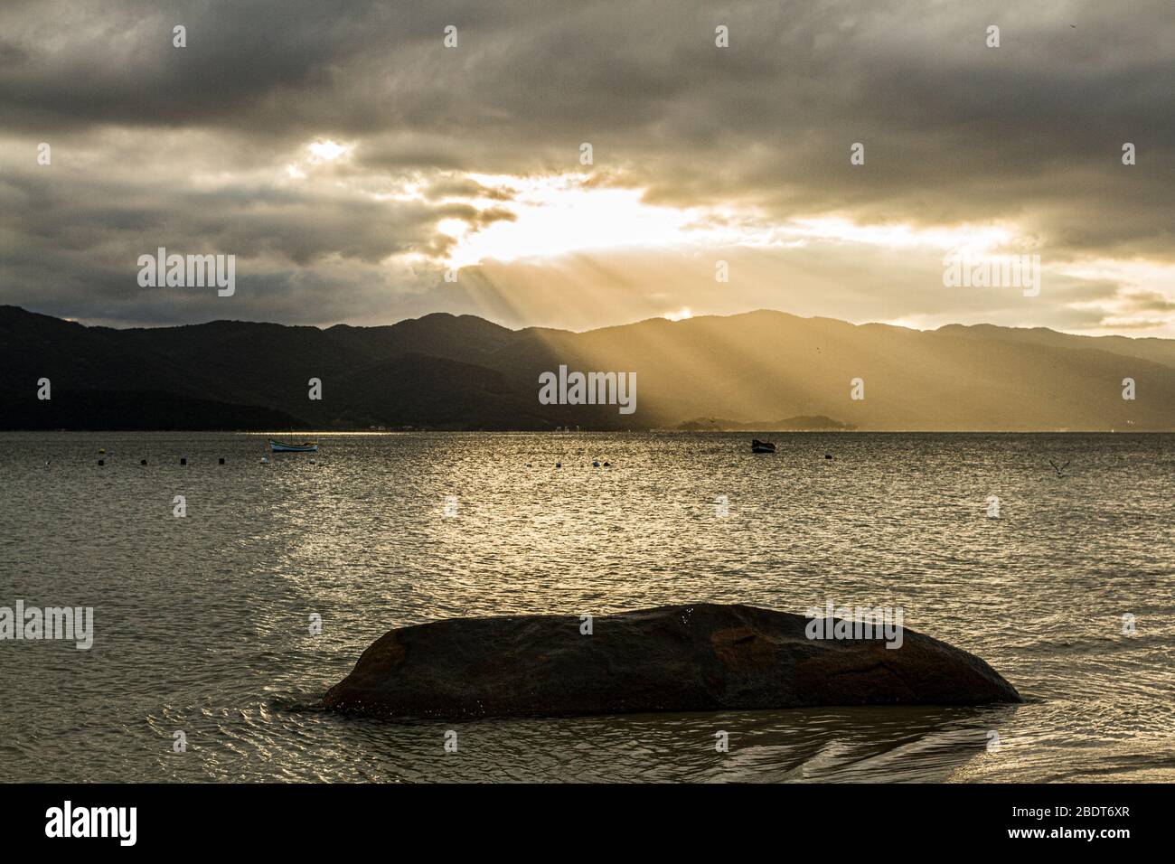 Rays of sunlight seen from Forte Beach at late afternoon. Florianopolis, Santa Catarina, Brazil. Stock Photo
