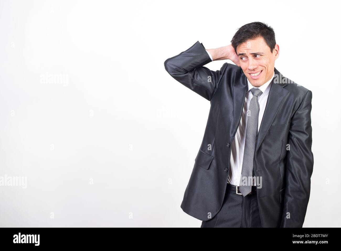 Shy man in suit. White background, Medium shot Stock Photo
