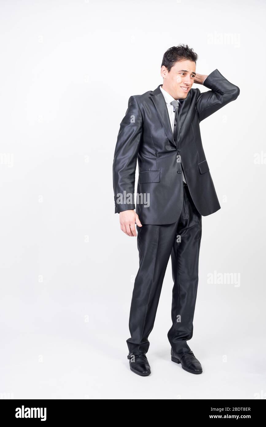 Shy man in suit. White background, full body Stock Photo