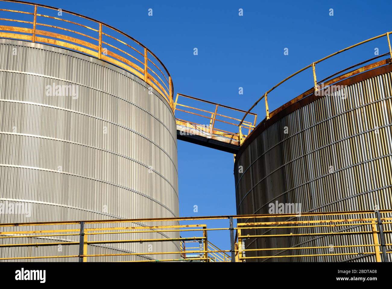 fuel oil storage tanks against a blue sky Stock Photo