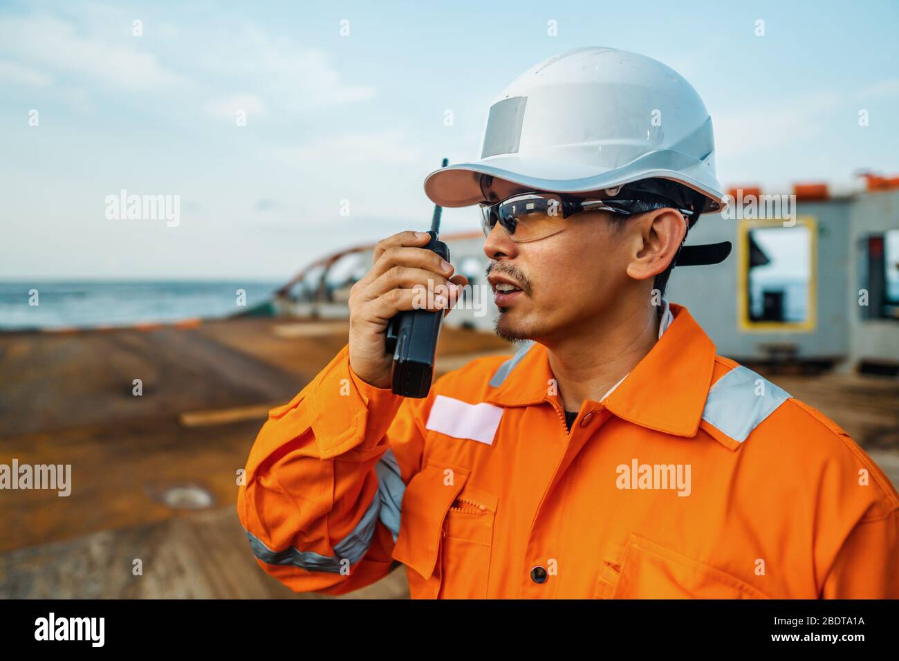 Filipino deck Officer on deck of vessel or ship , wearing PPE personal