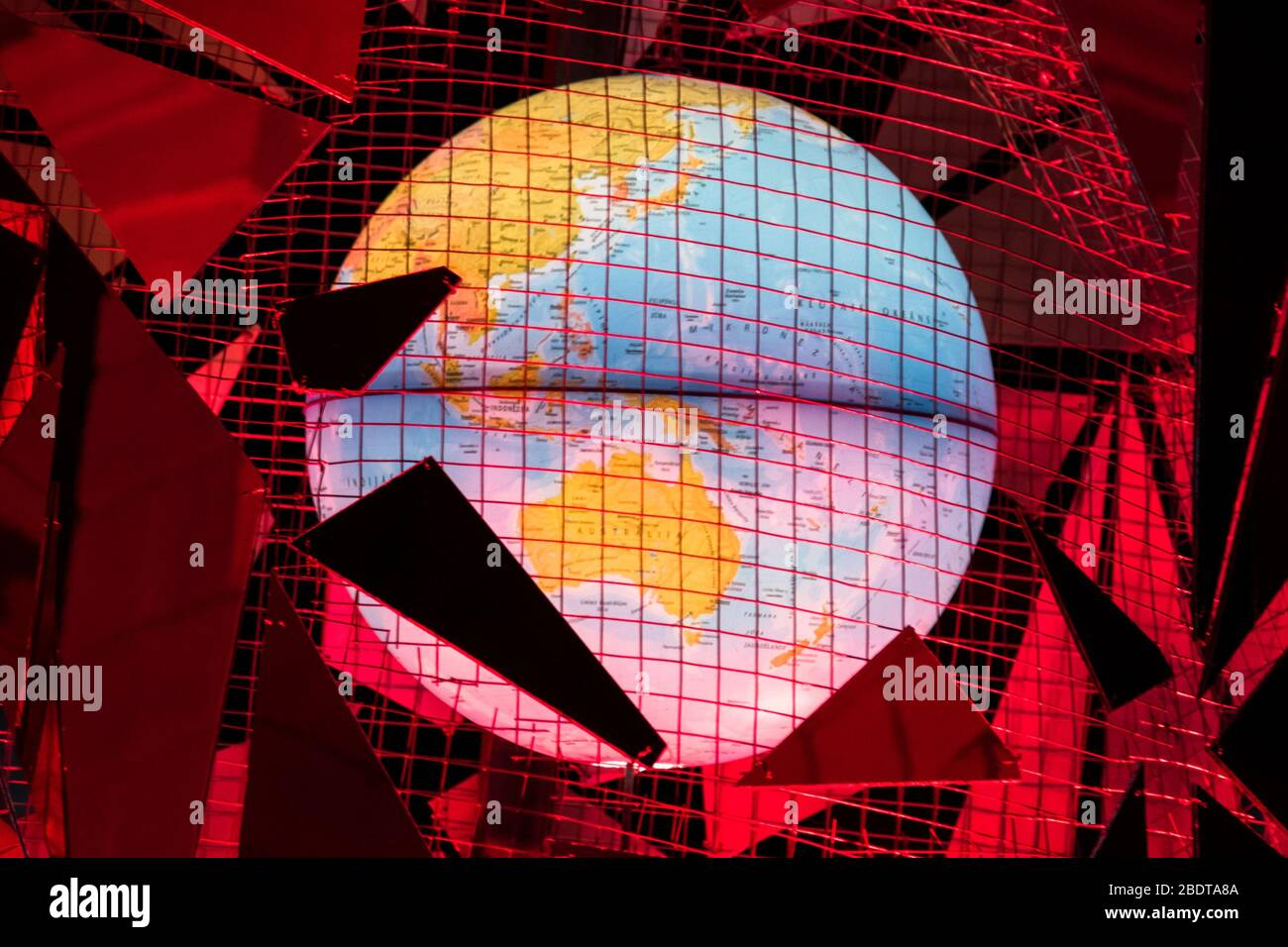 Futuristic construction made of mirror pieces and globe in the middle. Stock Photo