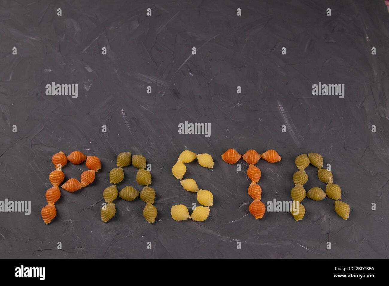 The Words PASTA Drawn With A Kind Of Pasta Conchiglie Textured Italian Food Background Concept 