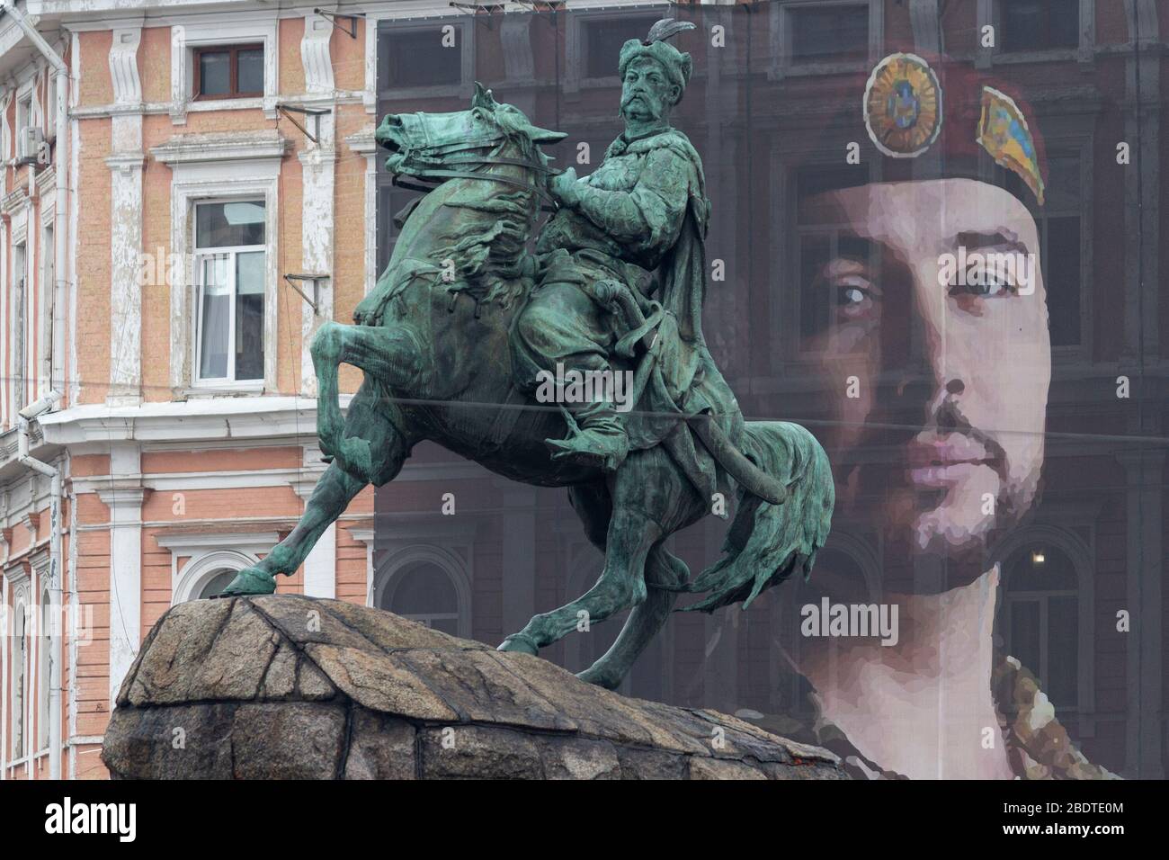 Kiev, Ukraine - January 31, 2020: A view of the monument to Bogdan Khmelnitskii and a banner with a portrait of the defender of Ukraine Vitaliy Markiv Stock Photo