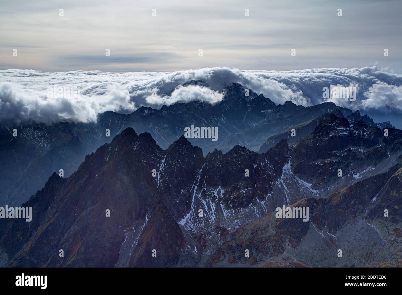 Inverted cloud rolling down over the peaks of the High tatra Mountains ...