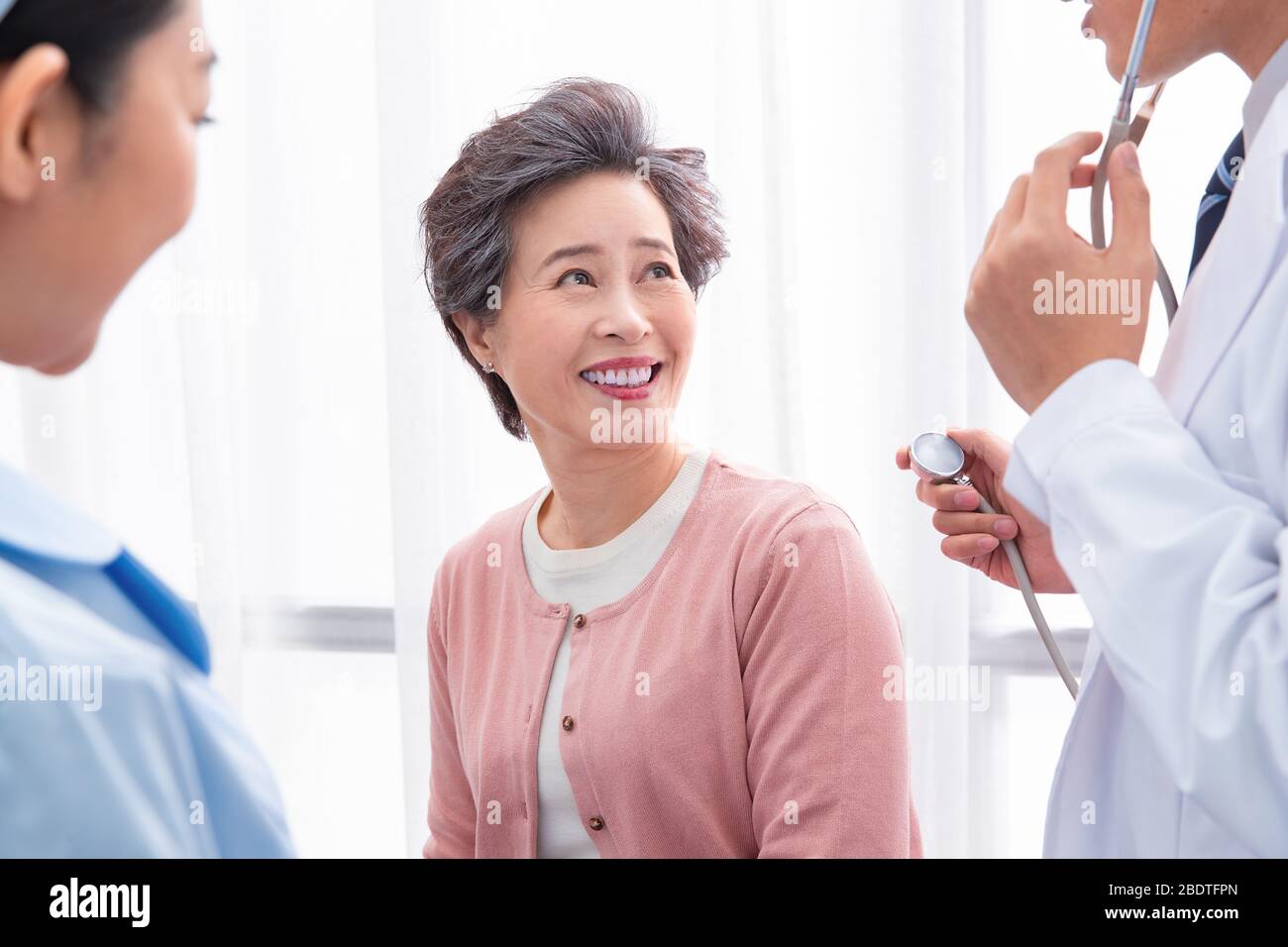 The doctor talked with elderly patients Stock Photo