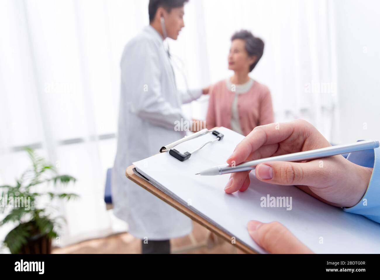 The doctor talked with elderly patients Stock Photo