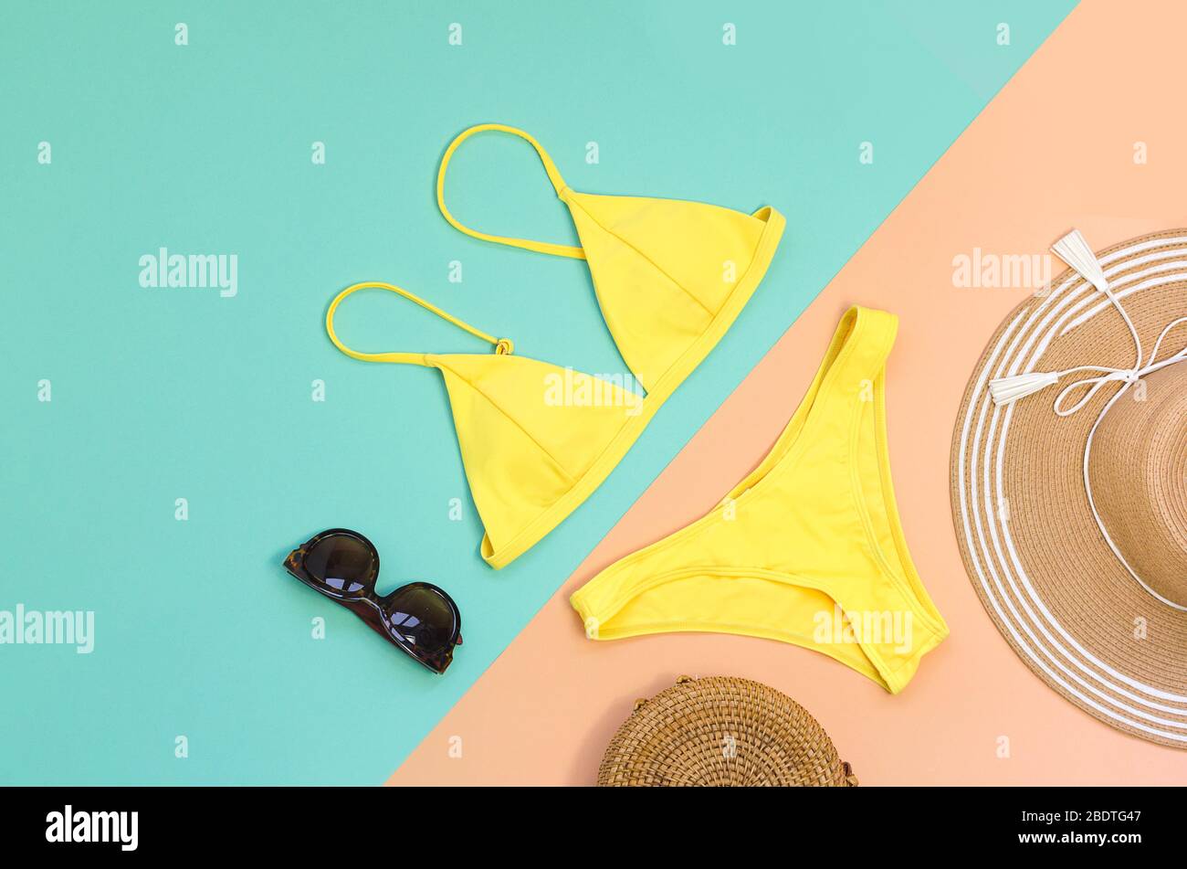 Swimming suit with sunglasses, bag and straw hat for summer. Flatlay Stock Photo