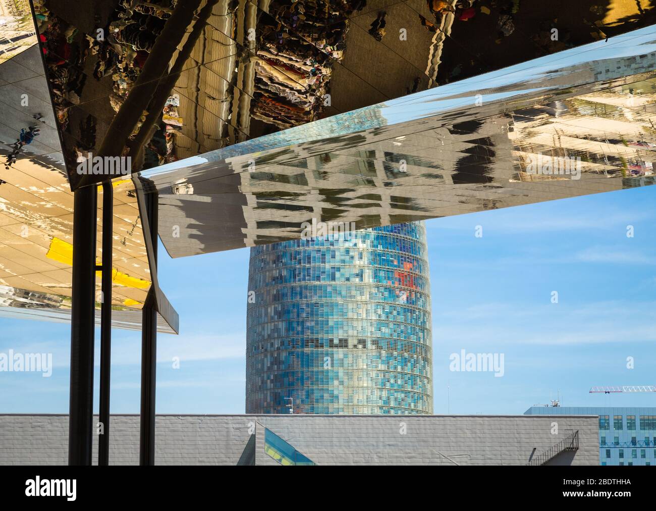 Reflection in mirrored roof of the Encants Vells Flea Market, with the Agbar Tower in the background, Barcelona Spain. Stock Photo