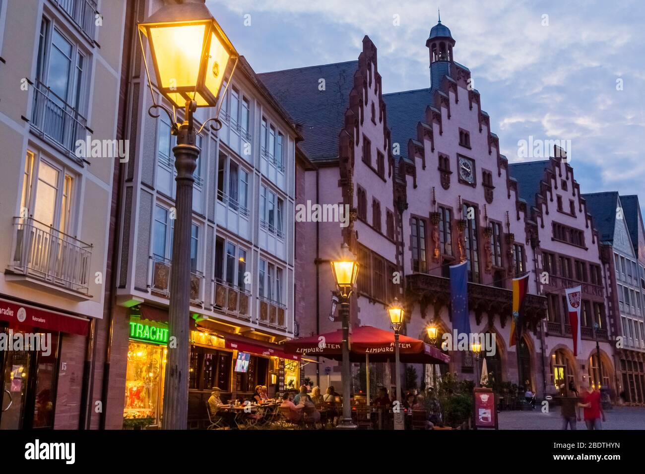 Tourists and locals eating and drinking in the old town or Alstadt of Frankfurt. The reconstruction of Romer was completed in 2017. Stock Photo