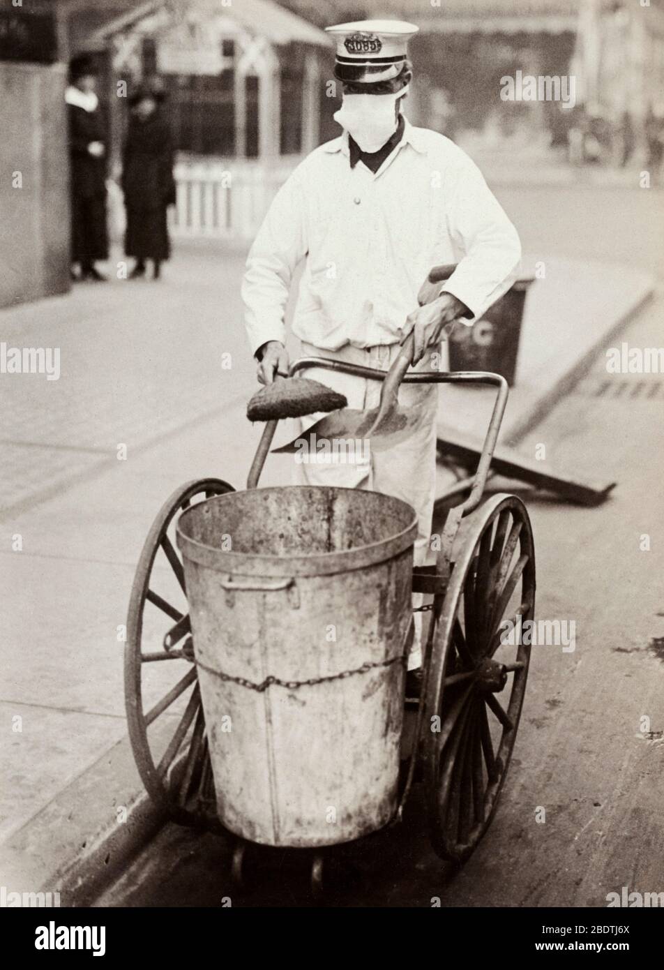 Street Cleaner with Influenza Mask during 1918 Spanish Flu Pandemic Stock Photo