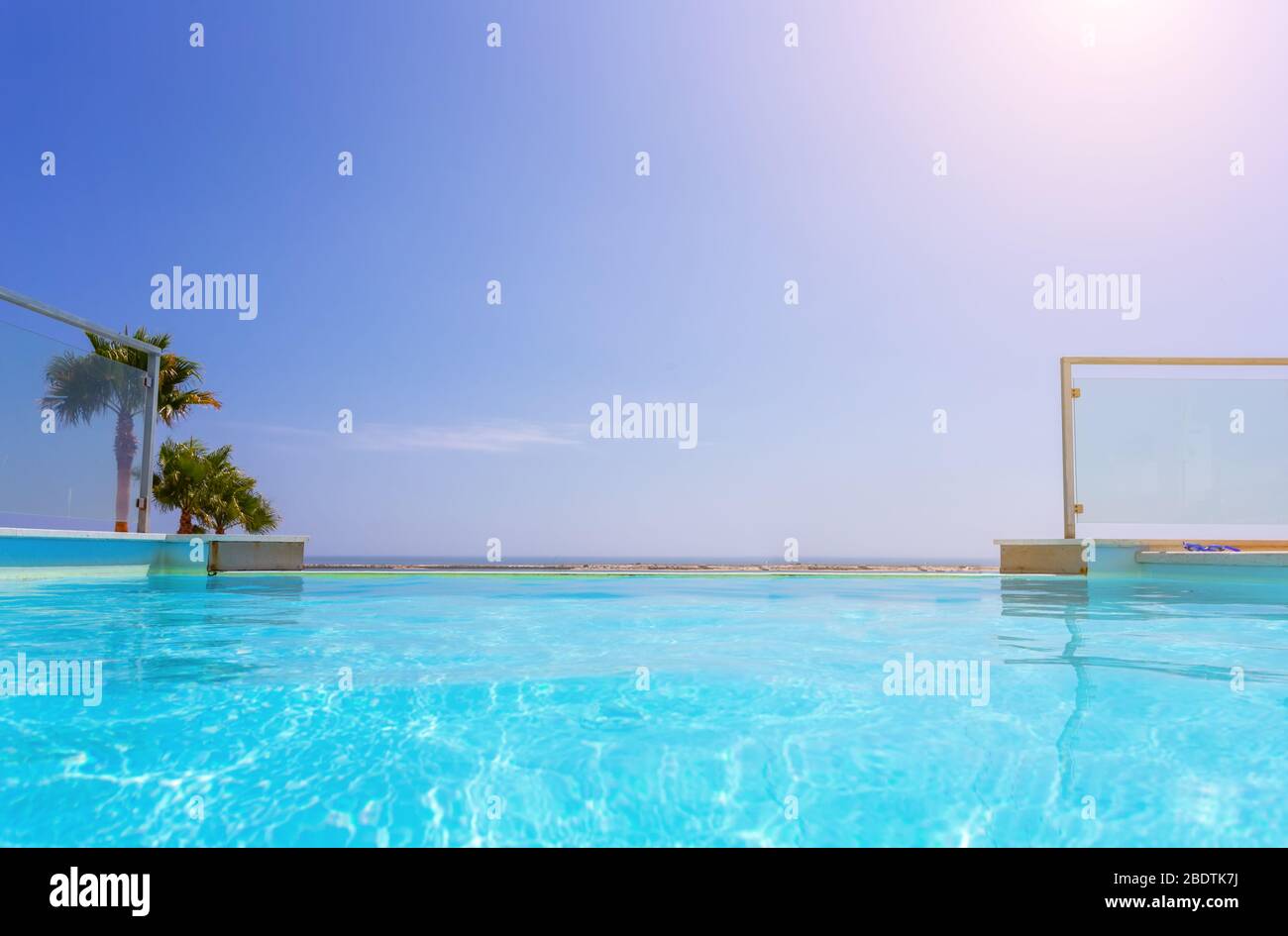 Luxury swimming pool and blue water at the resort with beautiful sea view.  Stock Photo