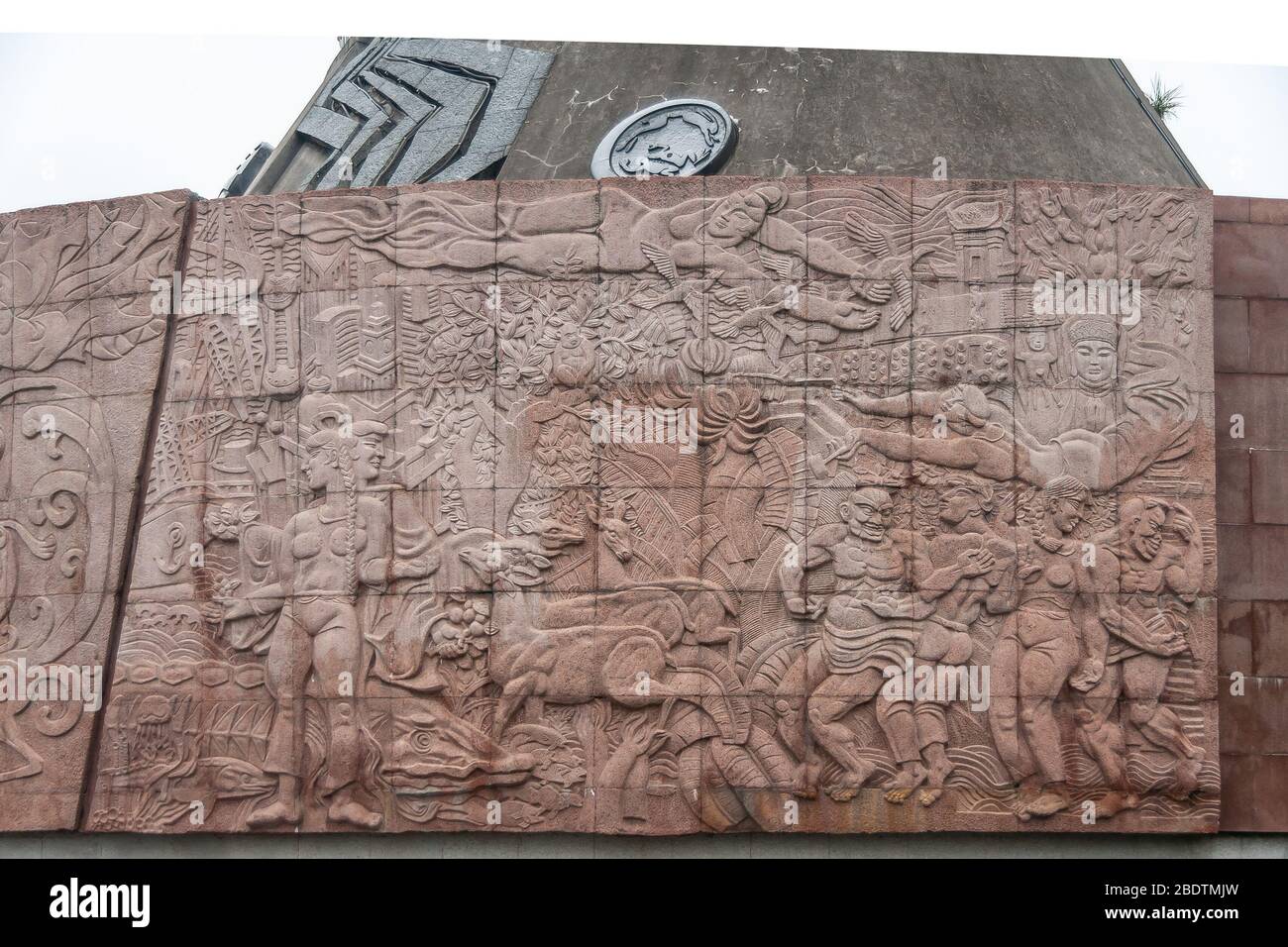 Three Gorges Dam, China - May 6, 2010: Yangtze River. Brown stone mural fresco densely loaded with human and animal figures, and symbols at reception Stock Photo