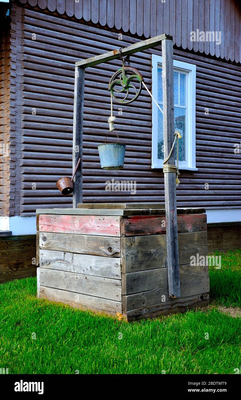 An outside well that was the main source of water for homes built in the earlier years Stock Photo