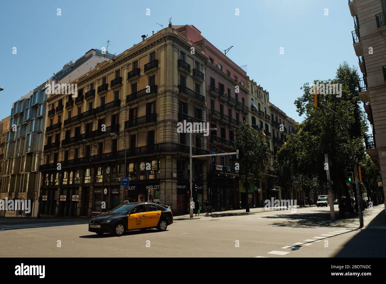 Barcelona, Spain April 2020: A taxi passing by Via Laietana, completely empty due to the Corona Virus Outbreak Stock Photo