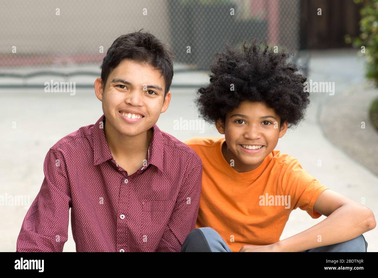 Young mixed race teenage brothers looking at the camera Stock Photo