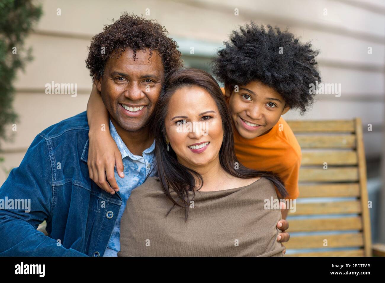 Portrait of a mixed race family smiling. Stock Photo