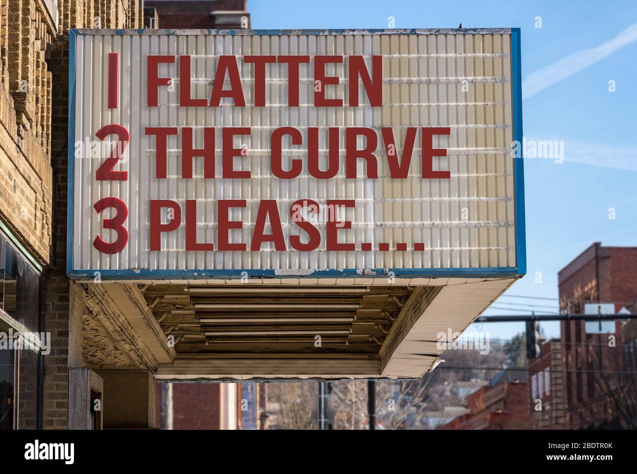 Concept illustration of movie cinema billboard with flatten the curve, please, message to help healthcare workers deal with the coronavirus epidemic. Stock Photo