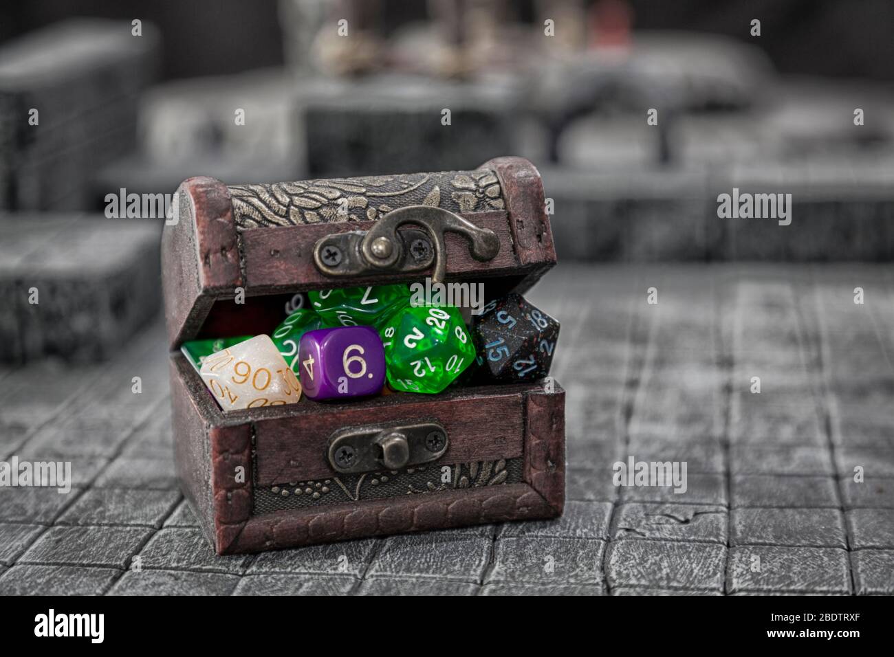 A treasure chest bulging with dice for role palying game. Stock Photo