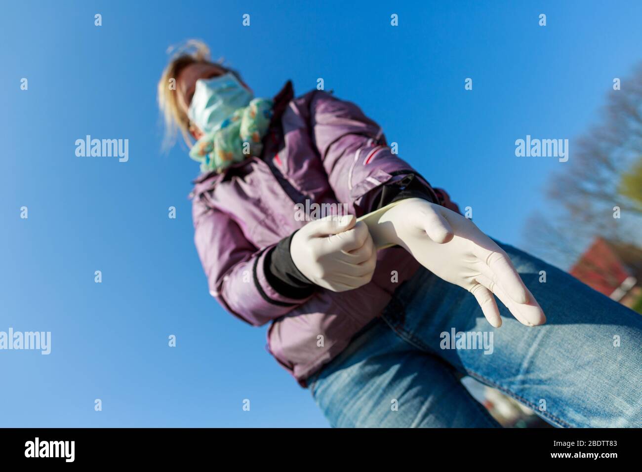 A german woman with a mouth protector and gloves Stock Photo