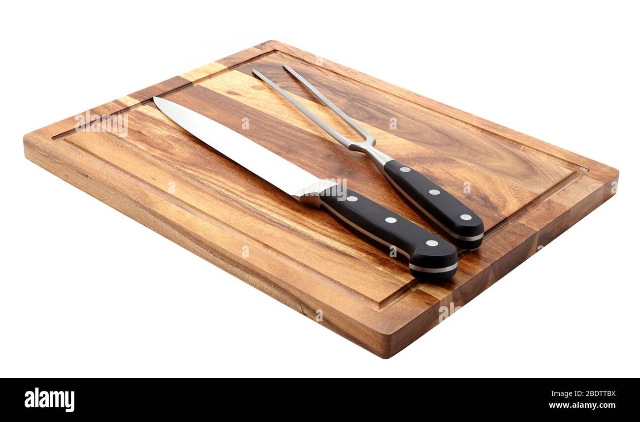 Knife and fork on cutting board Stock Photo