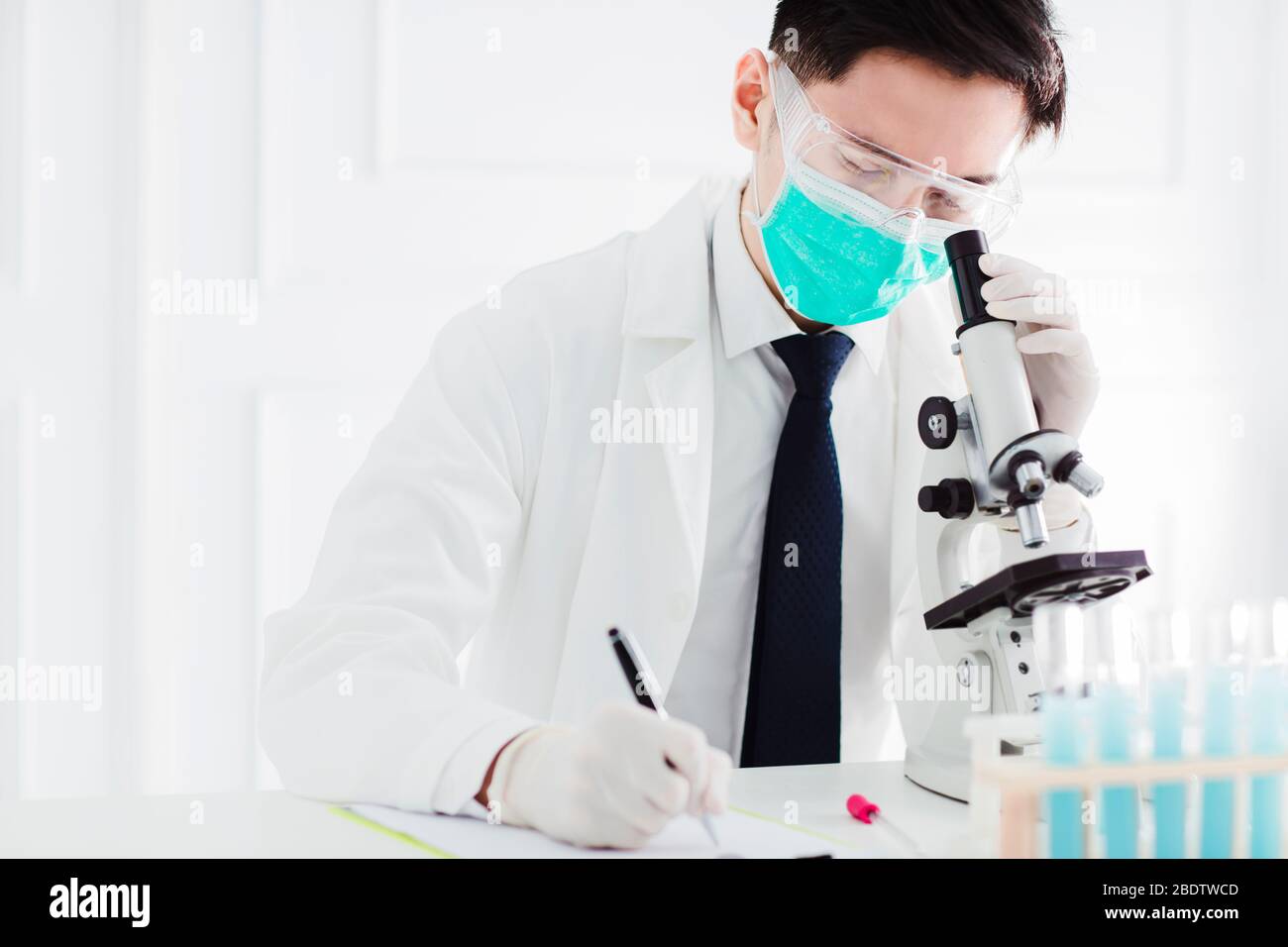 scientist in the laboratory working at lab with microscope Stock Photo